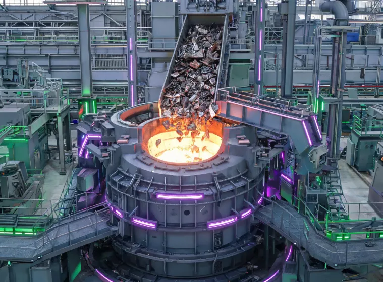 Recycled steel charge entering electric arc furnace